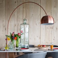 Product photograph of Zuiver Metal Bow Floor Lamp - Copper from Cuckooland