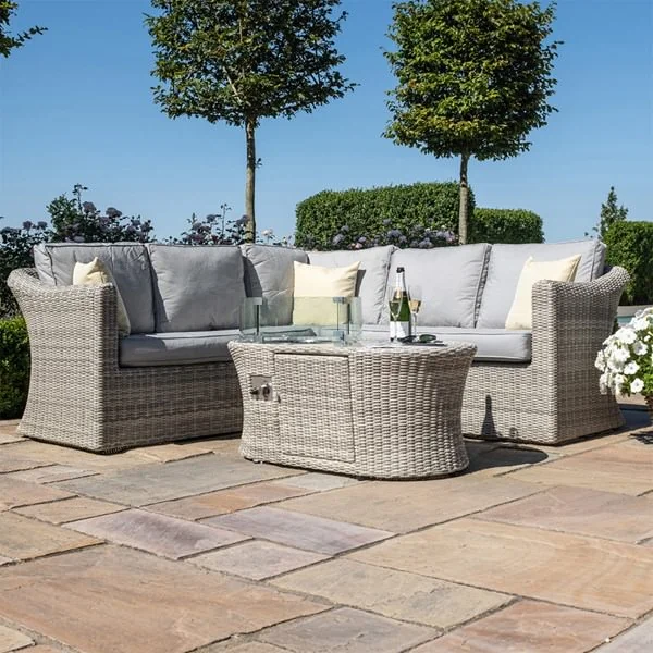 Grey rattan garden sofa set with firepit