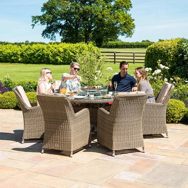 Garden dining table with cushioned chairs