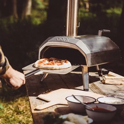 Ooni karu pizza oven with perforated pizza peel