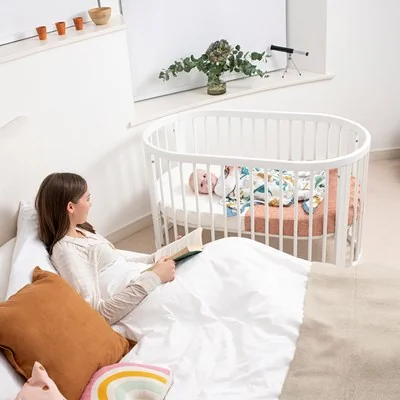Smooth spindle white baby cot with lockable castors