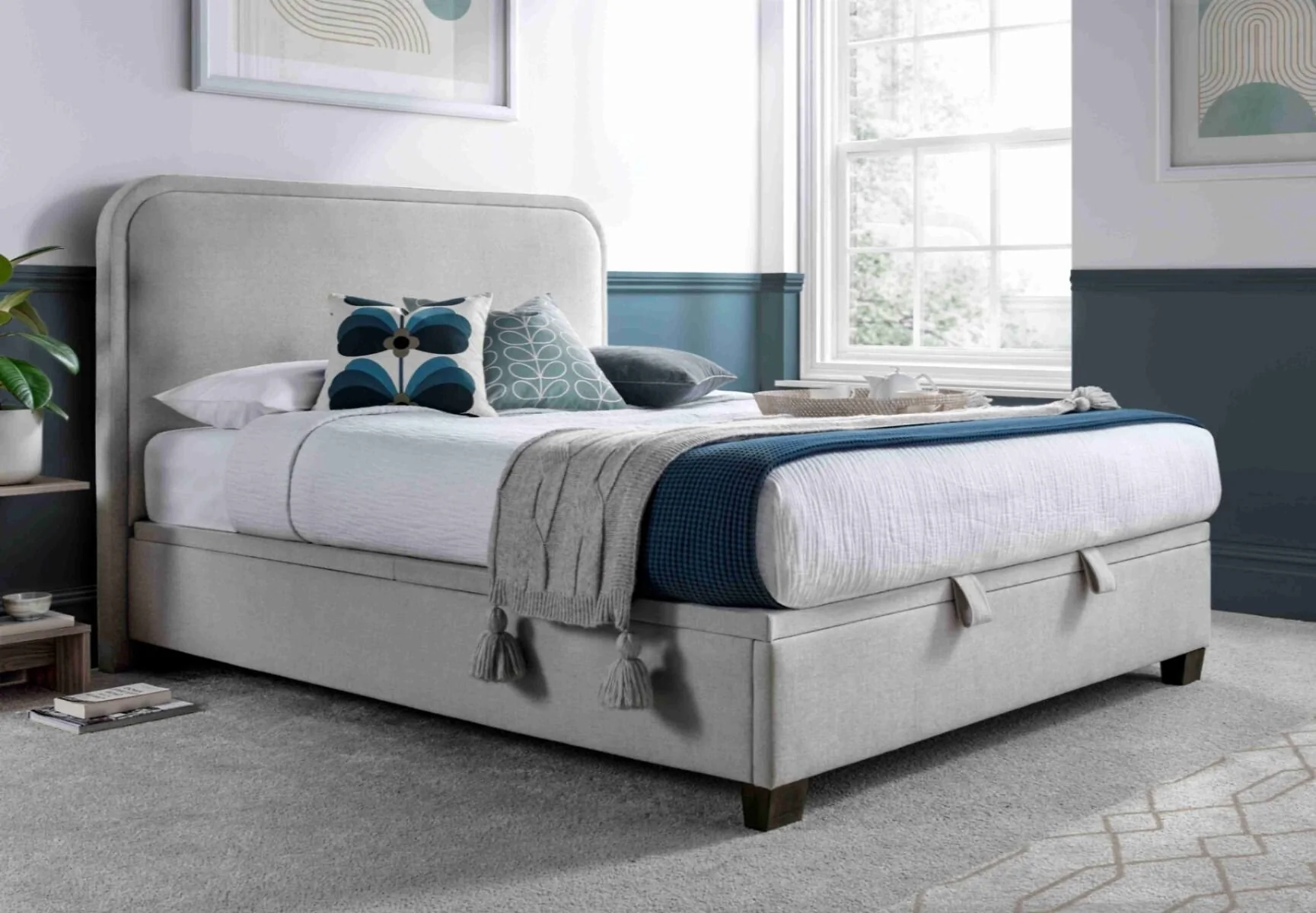 Kaydian Clifton fabric upholstered ottoman storage bed with curved headboard in Maskat Clay